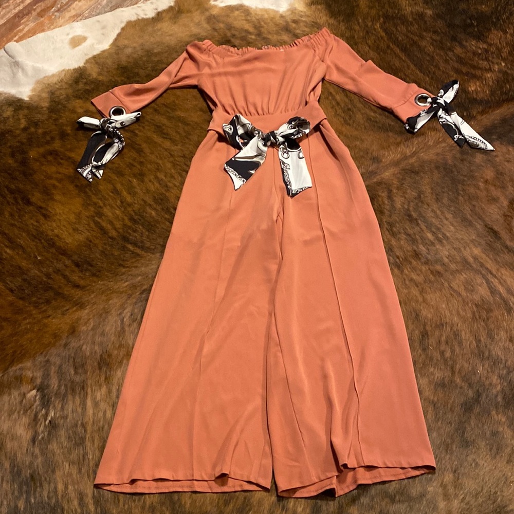 Size medium off the shoulder jumpsuit. Color is almost dark coral